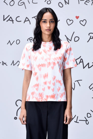 Women coral peach graphic t-shirt with heart motif, designer casual wear UAE