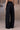 Black relaxed trousers for women in poly wool fabric by Genes Lecoanet Hemant UAE