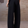 Black relaxed trousers for women in poly wool fabric by Genes Lecoanet Hemant UAE
